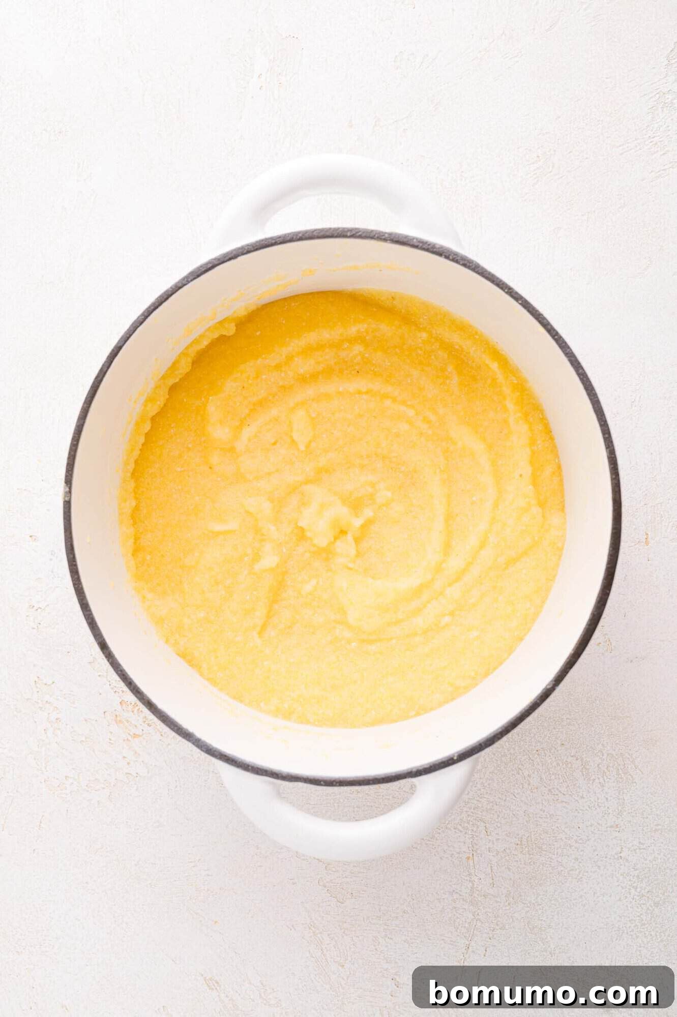 White pot filled with cooked polenta.