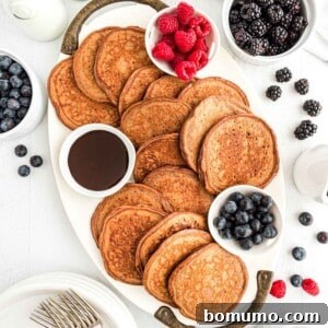 Chocolate protein pancakes spread out on a platter.