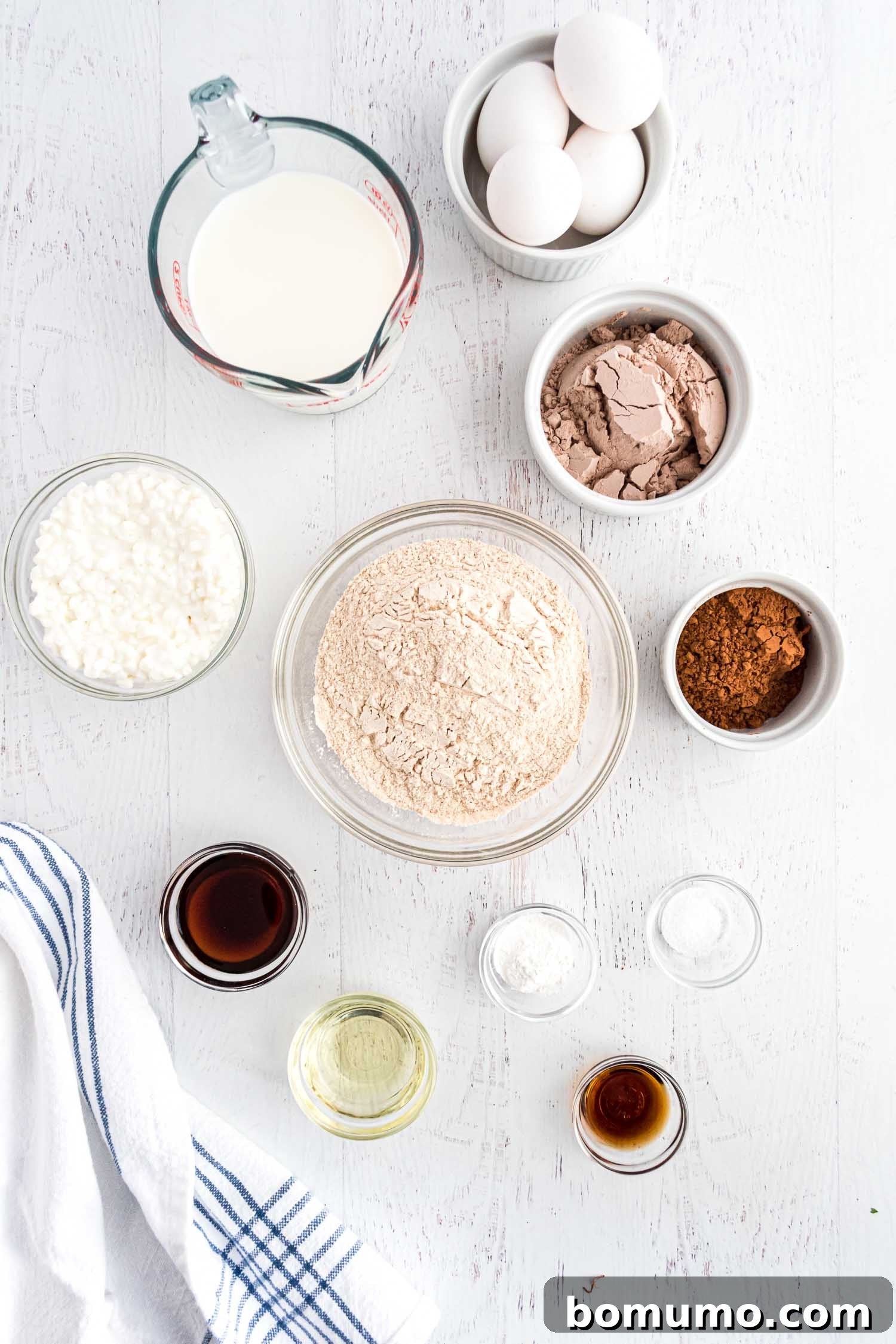 An overhead view showcasing all the fresh, high-quality ingredients needed for these healthy chocolate protein pancakes.