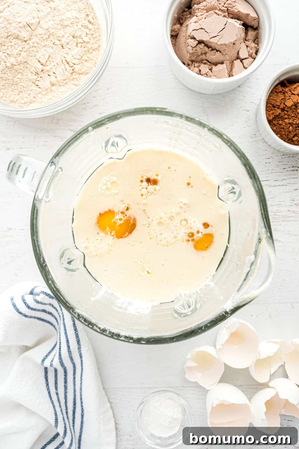 Wet ingredients (eggs, milk, cottage cheese, oil, vanilla, maple syrup) ready in a blender.