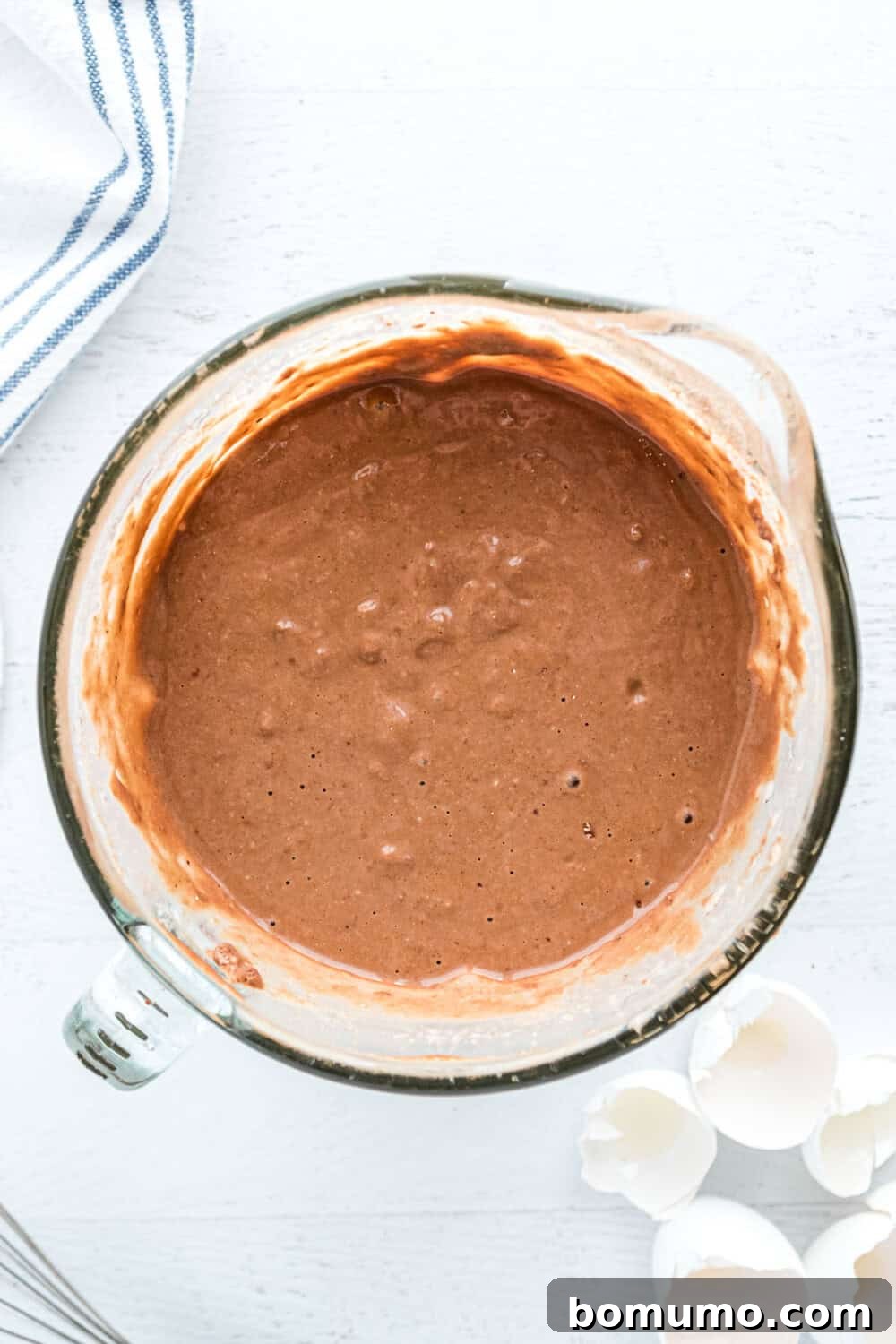 Smooth chocolate pancake batter ready in a bowl, blended to perfection.