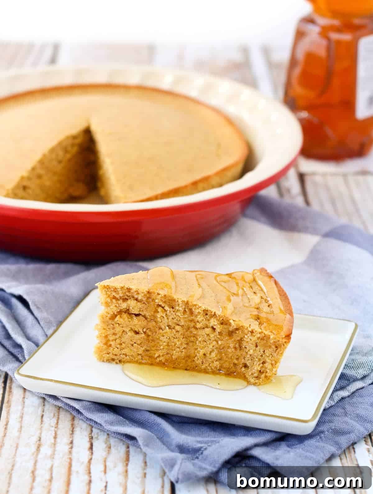 Slice of healthy cornbread on a plate, perfectly golden brown and inviting.
