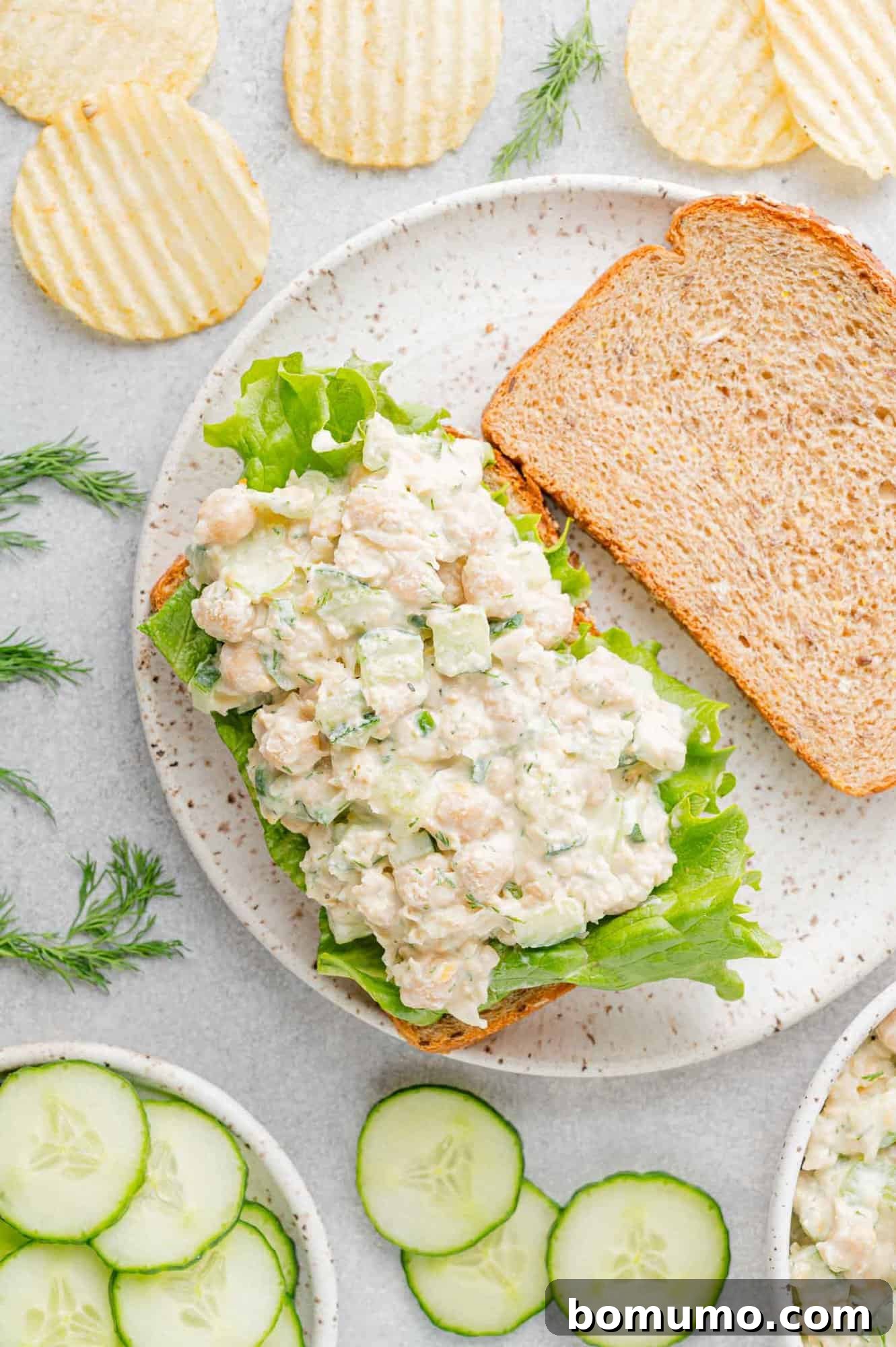 Overhead view of a delectable open-faced chickpea salad sandwich, showcasing its vibrant ingredients.
