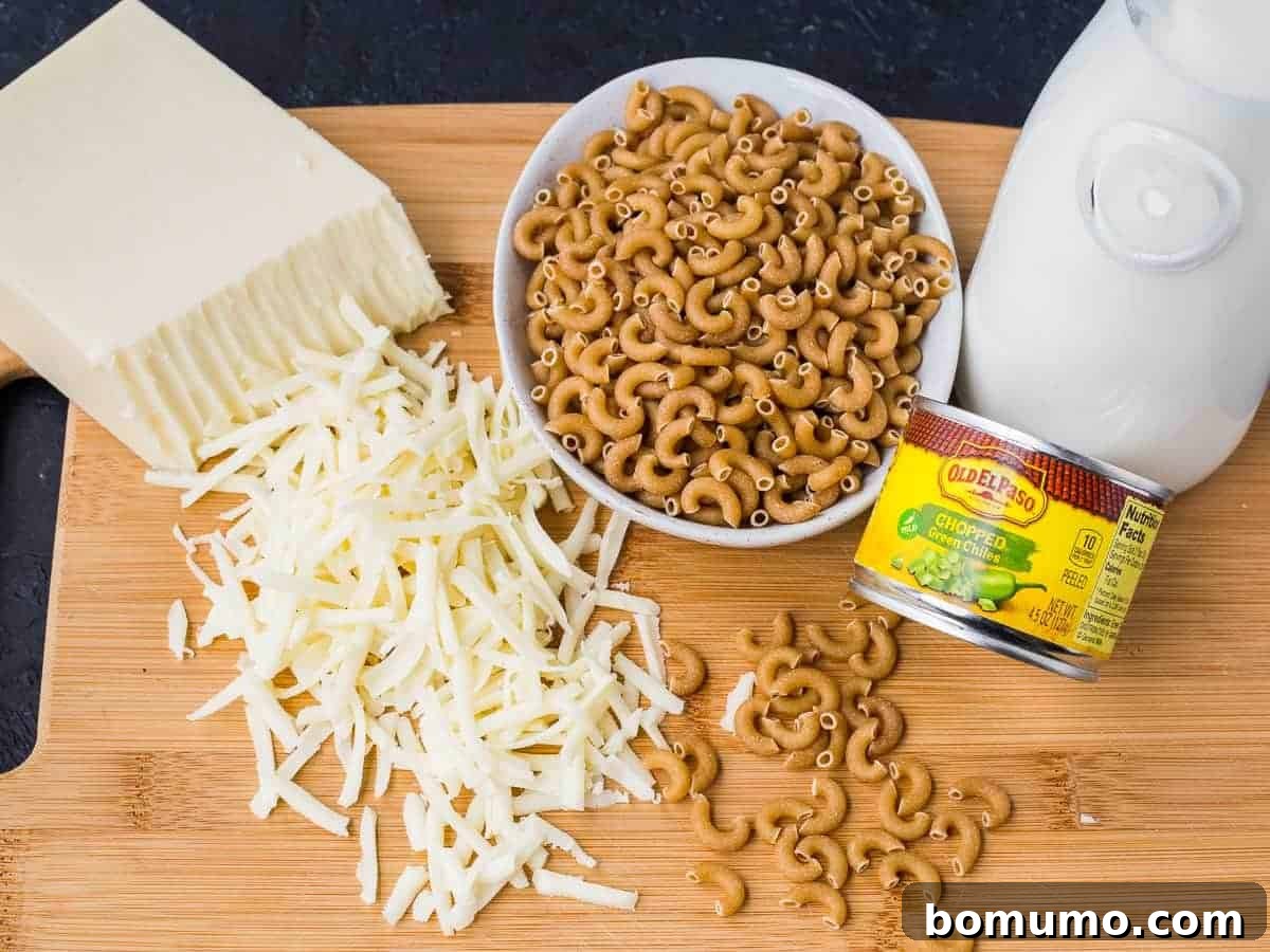Southwest Mac Delight 3 A collection of the 5 main ingredients needed for the green chile mac and cheese recipe: macaroni, shredded cheese, flour, canned green chiles, and milk.