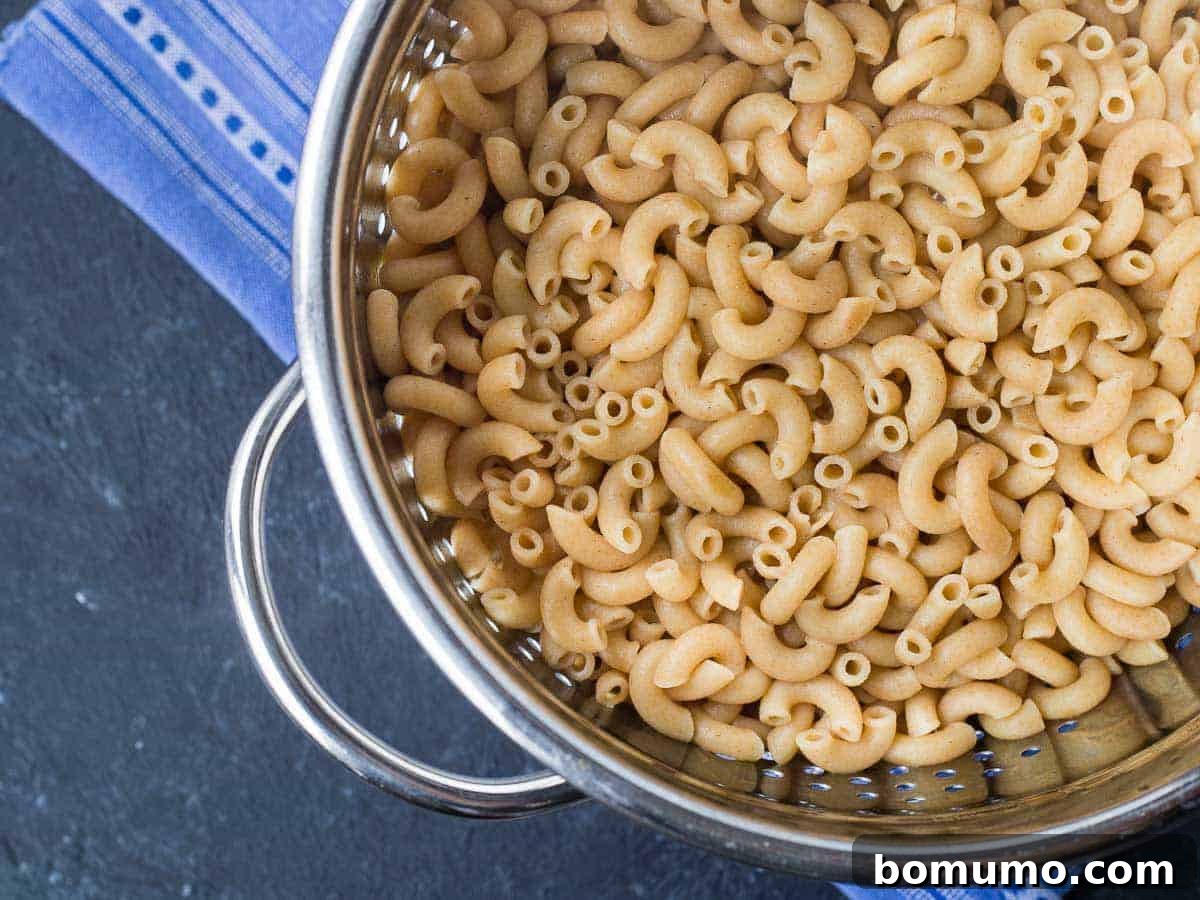 Southwest Mac Delight 4 Freshly cooked elbow macaroni pasta draining in a colander.