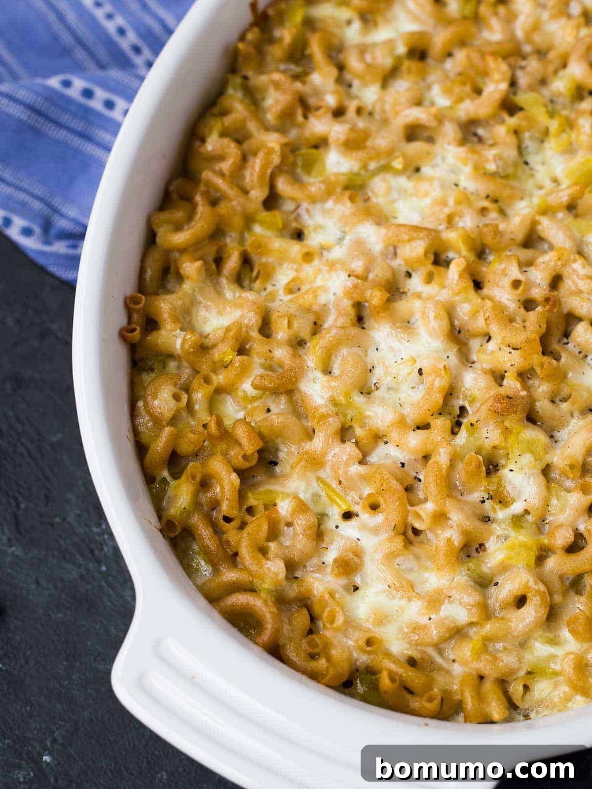 Southwest Mac Delight 5 A freshly baked green chile mac and cheese casserole in a white dish, bubbly and golden brown, ready to be served.