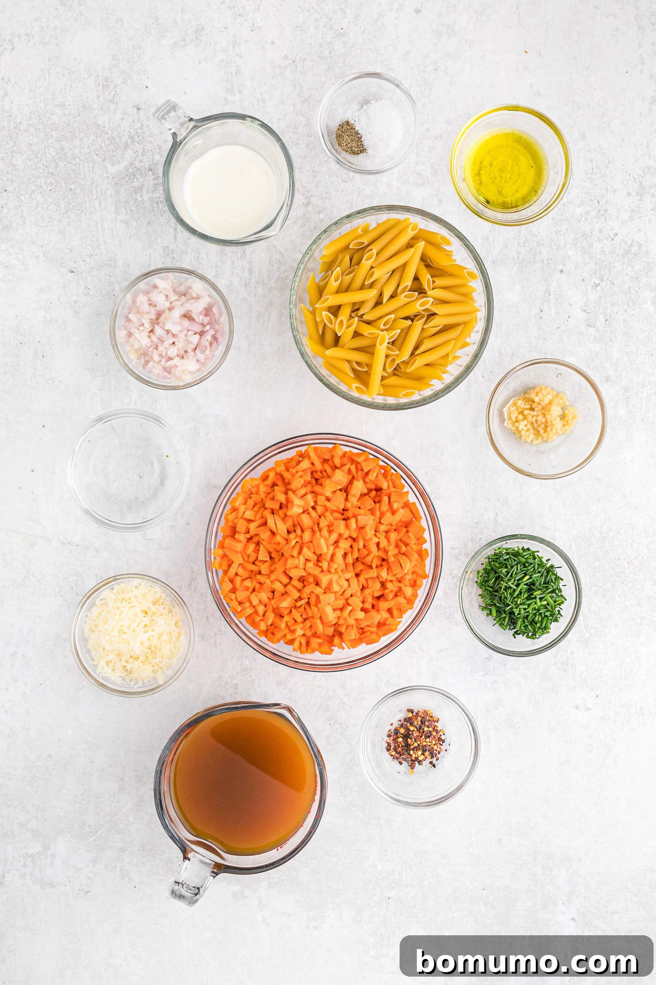 Carrot Sauce Symphony 4 Ingredients needed, in separate bowls, including carrots and chives.