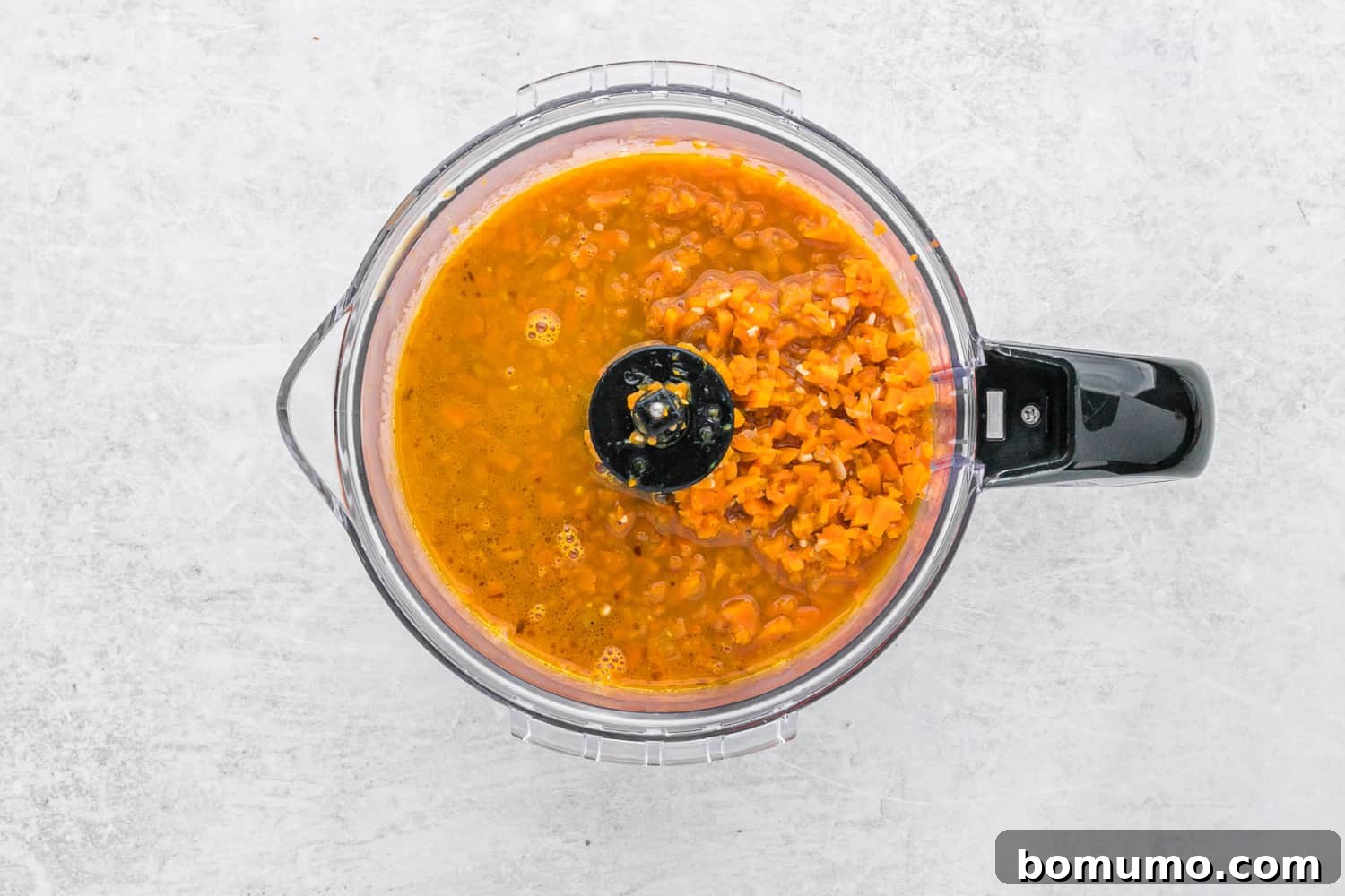 Carrot Sauce Symphony 8 Carrots in a food processor, partially blended.