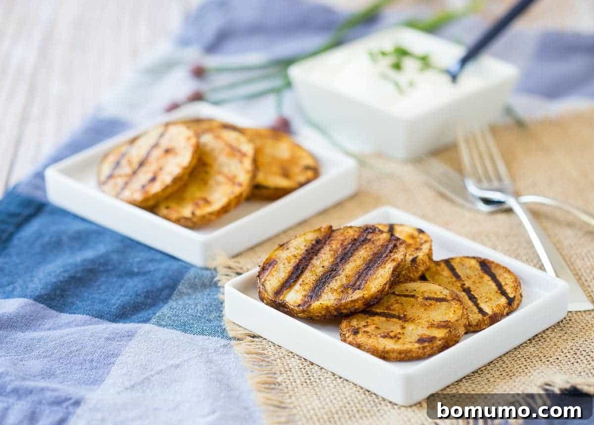 Grilled potato slices on small square white plates, along with forks and square dish of sour cream.