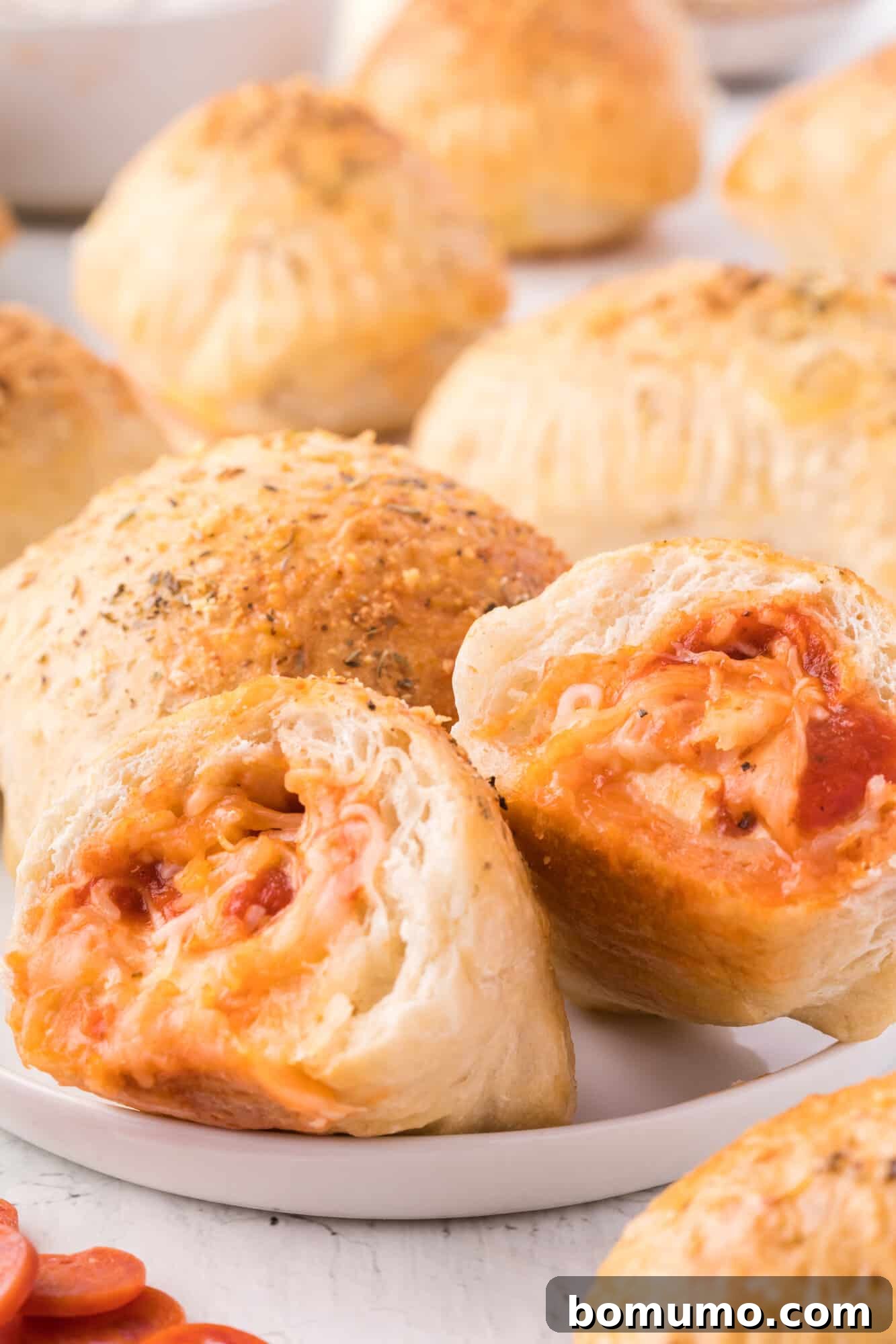Hot pocket cut open to show its melted cheese and pepperoni filling, inviting a bite.