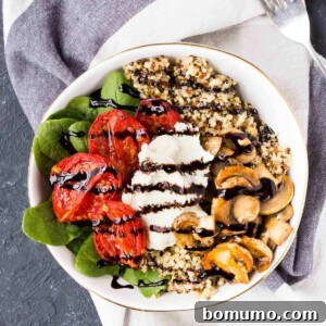 Overhead of shallow white bowl containing arranged salad with balsamic reduction drizzle.