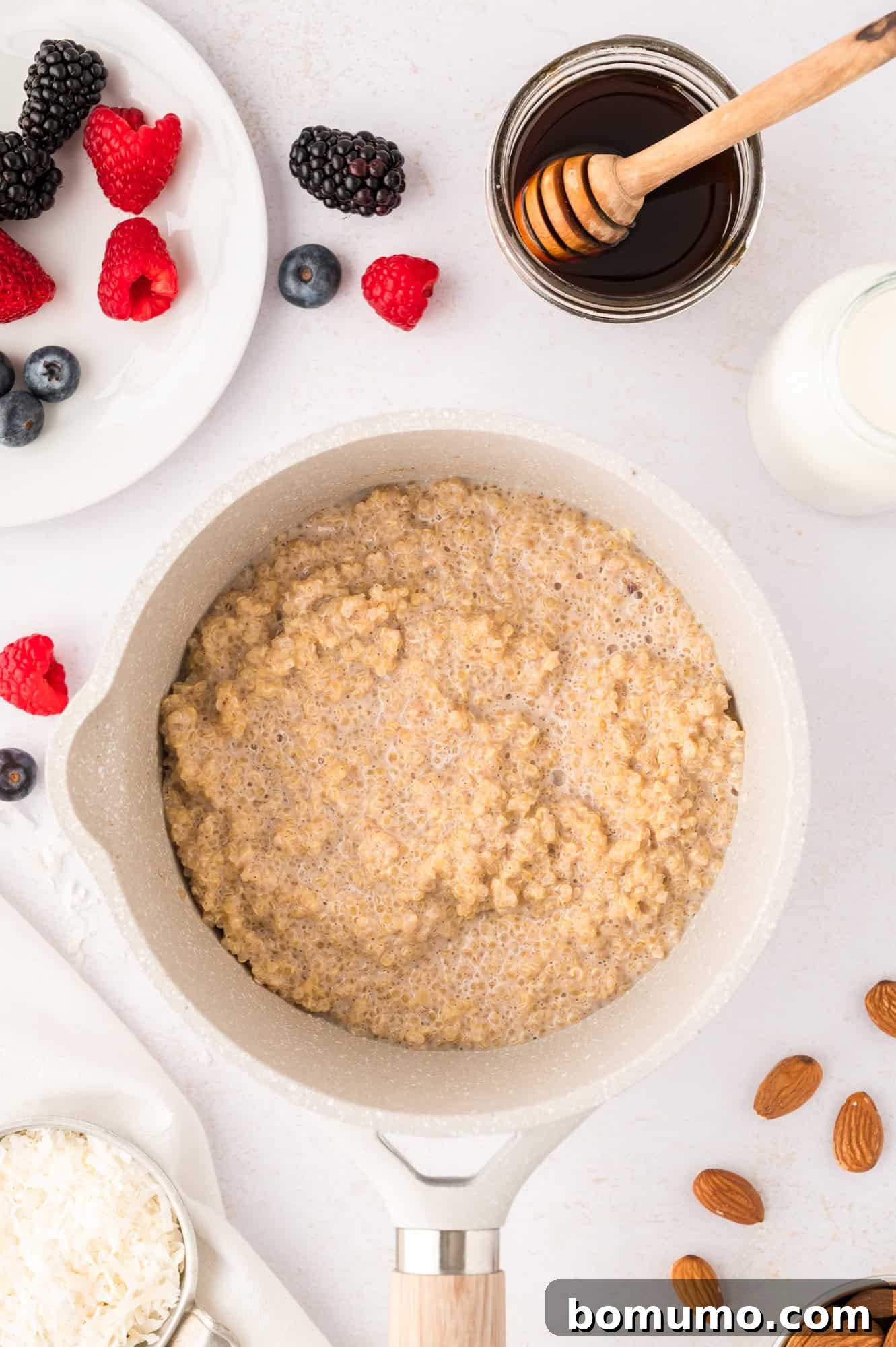 A saucepan filled with freshly cooked breakfast quinoa, now fluffy and perfectly tender, ready for serving and customization.