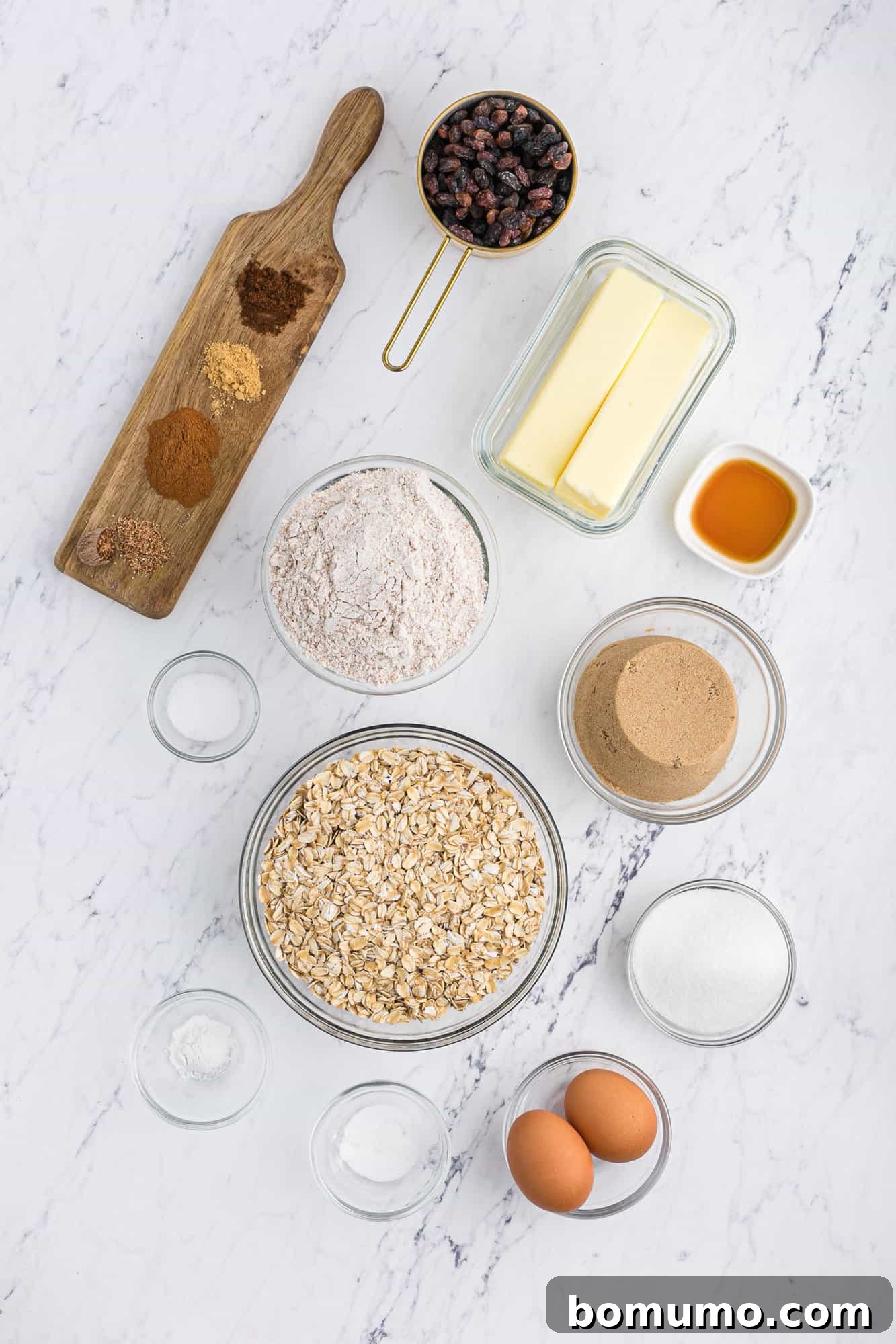 All the dry and wet ingredients laid out neatly for the oatmeal raisin cookie recipe.