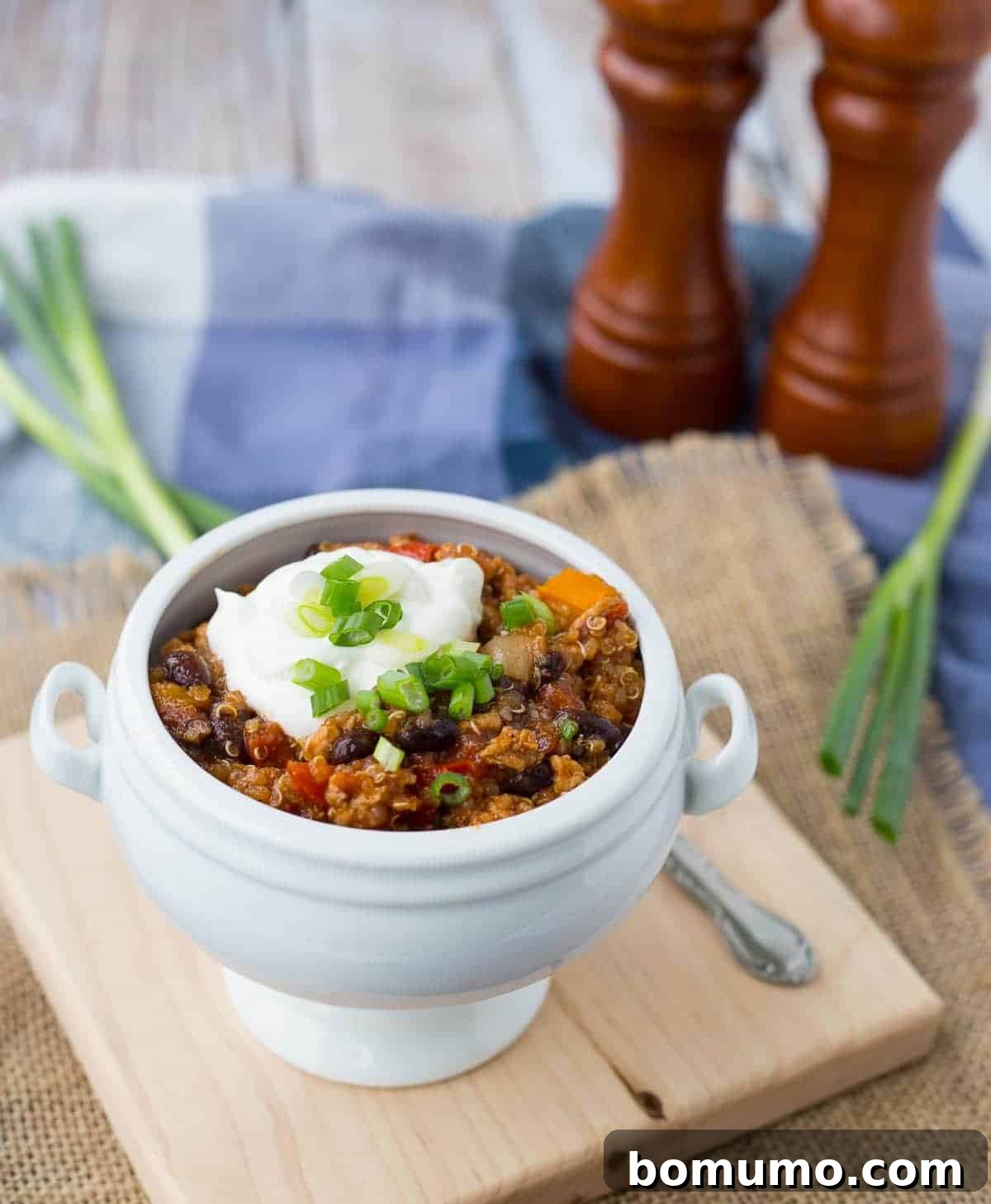 A close-up shot of healthy turkey quinoa chili in a white bowl, ready to be enjoyed.