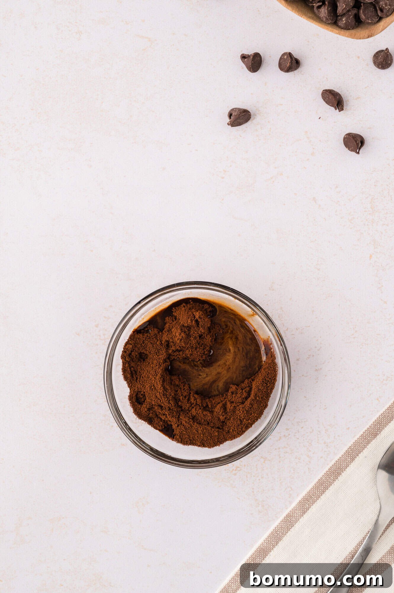 Espresso powder awaiting dissolution in a small bowl, highlighting the first step in preparing the coffee mixture.