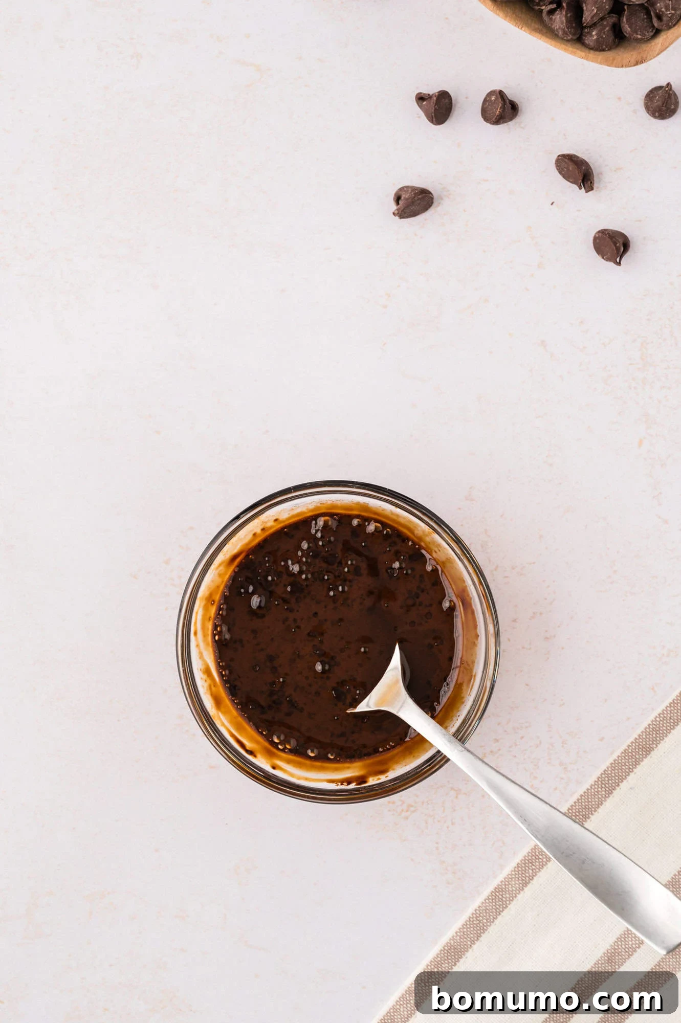 Hot water being added to espresso powder in a bowl, illustrating the process of dissolving the coffee for the cookies.