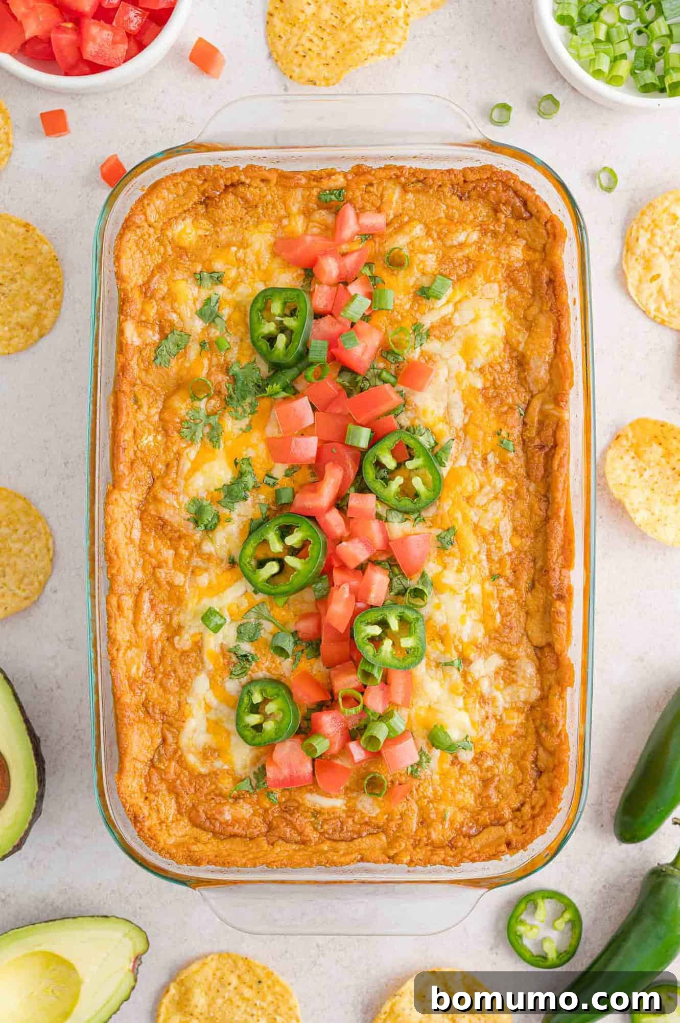 Smooth Bean Party Pleaser 11 Cheesy baked bean dip with various fresh toppings like cilantro and jalapeños.