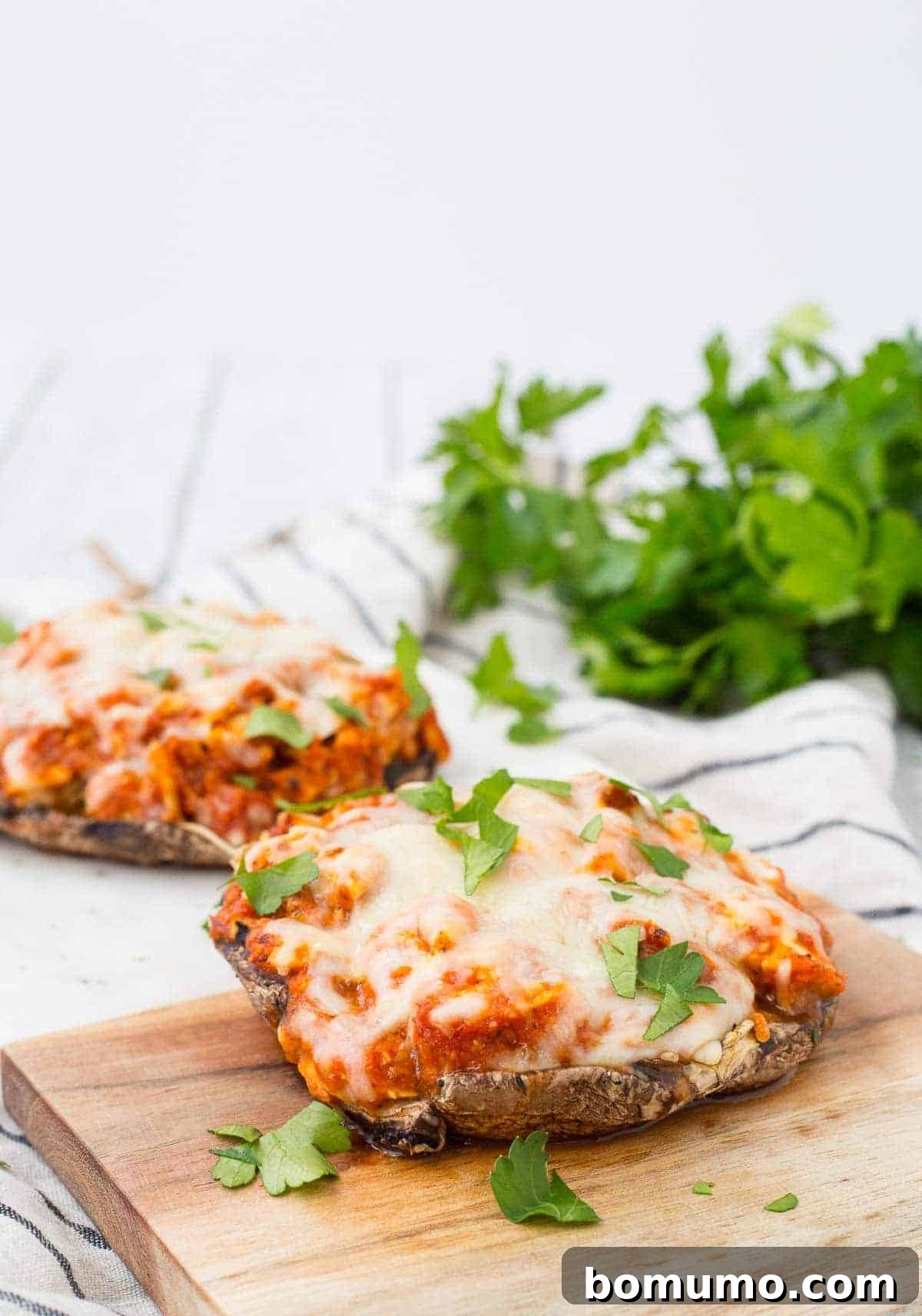 Close-up of two servings of stuffed portobello mushrooms, ready to be enjoyed.