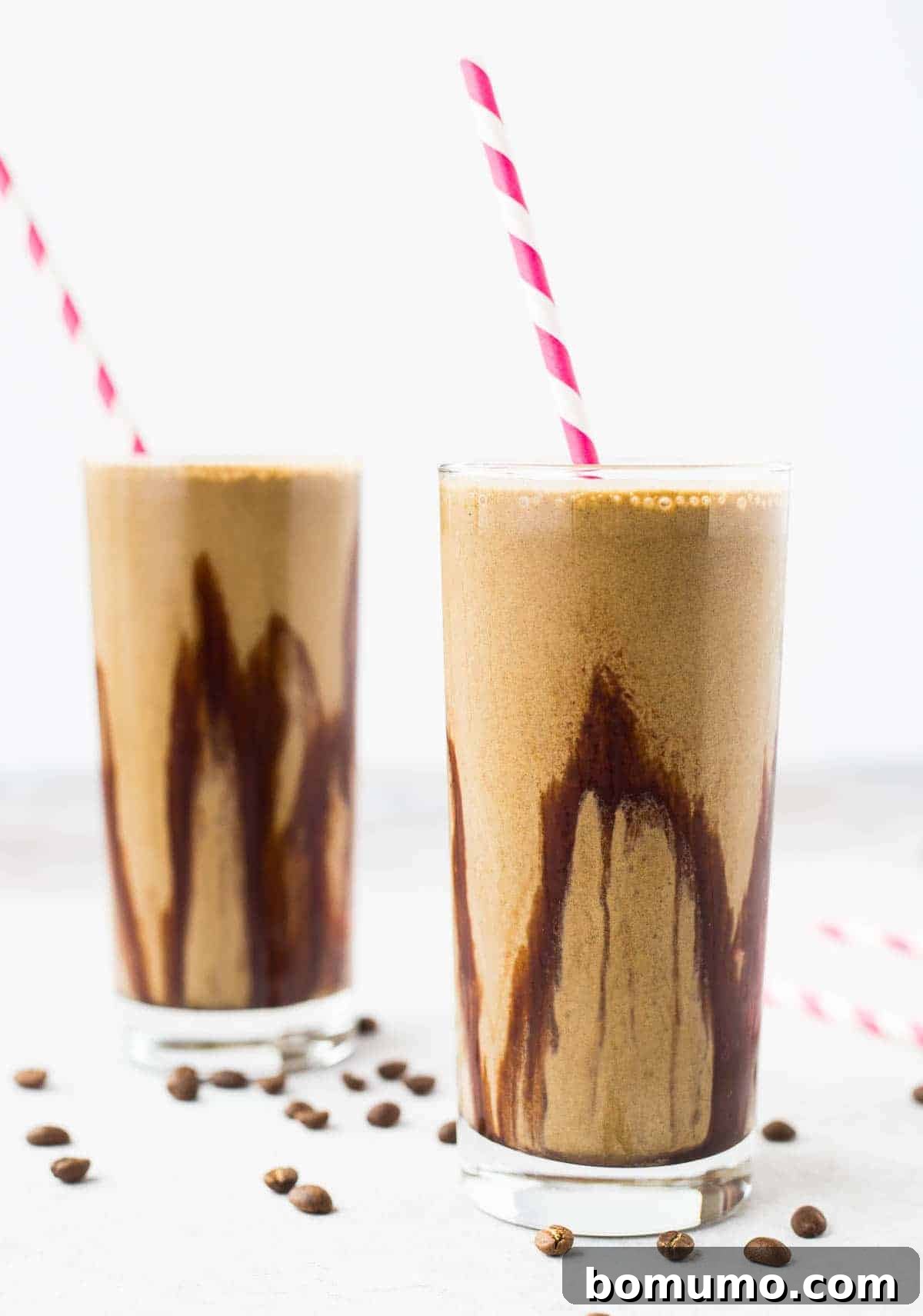 A vibrant mocha protein shake, elegantly presented in a glass adorned with a swirl of chocolate syrup, ready to be enjoyed as a healthy and delicious meal or snack.