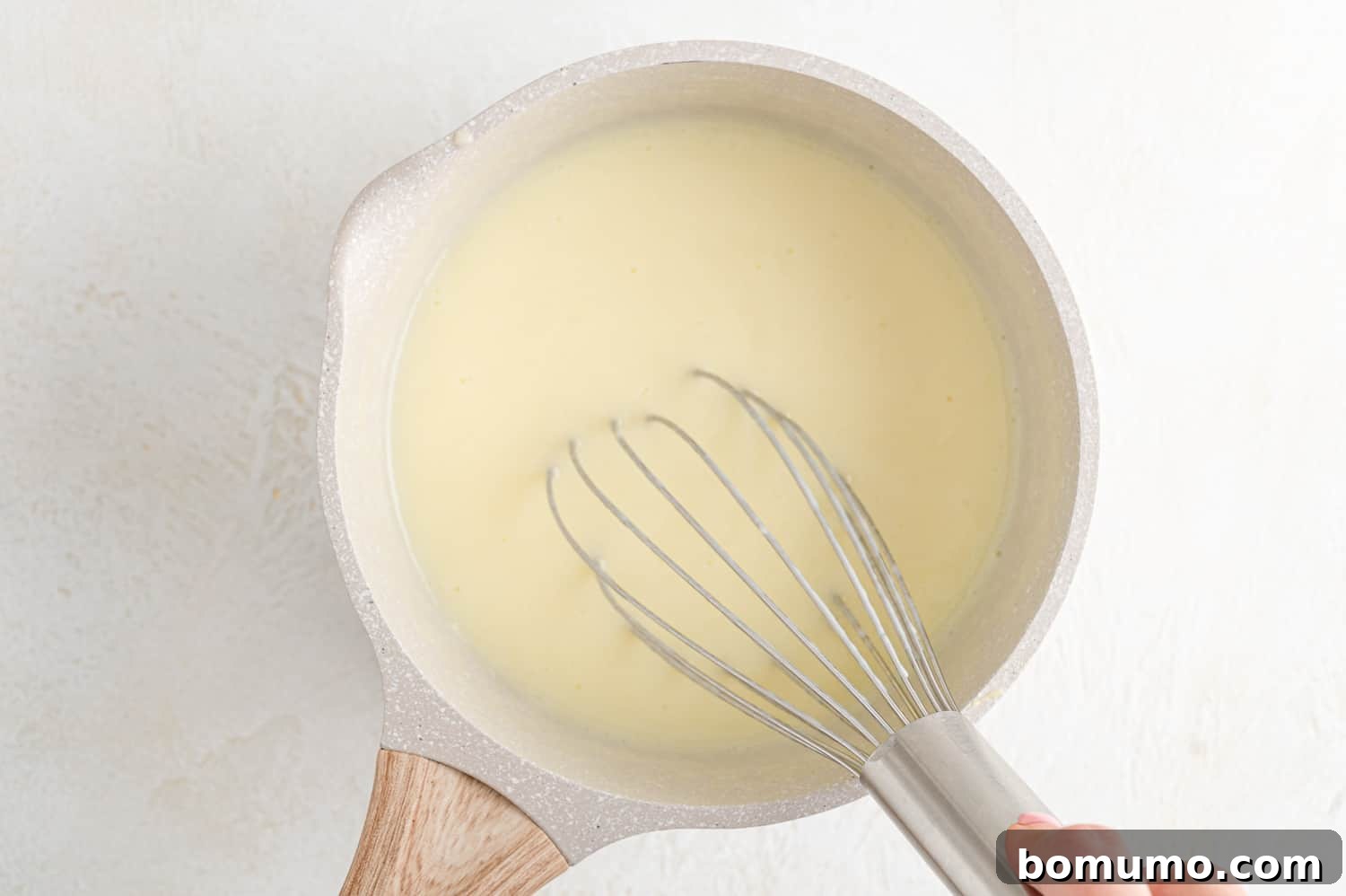 Dreamy Vanilla Pudding from Scratch 6 Milk being whisked in.