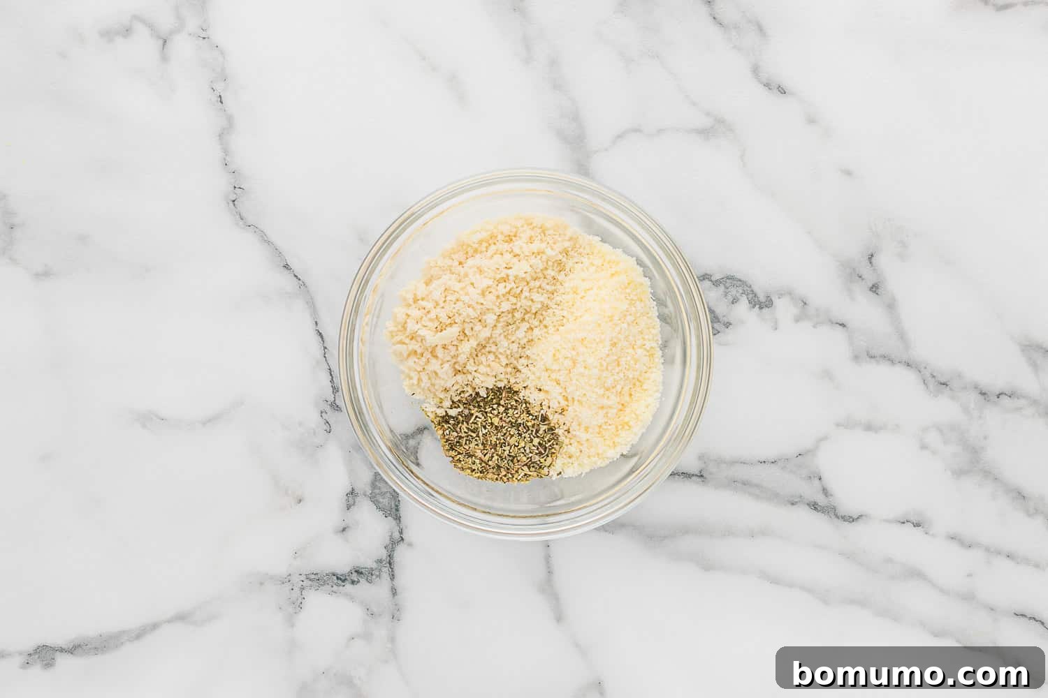Ingredients for the crispy topping, including panko bread crumbs, Parmesan cheese, and Italian seasoning, laid out before mixing.