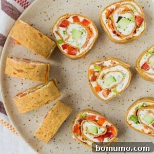 These vegetable cream cheese roll ups are full of crisp vegetables, flavorful herbs, and smooth cream cheese. They make a great lunch or snack thanks to extra protein in the wrap! Get the easy recipe on RachelCooks.com!
