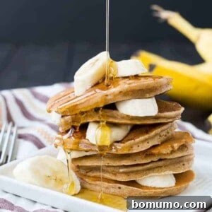 These easy and healthy banana pancakes taste just like banana bread in a whole wheat pancake form! They freeze well and will make mornings delicious! Get the healthy pancake recipe on RachelCooks.com!