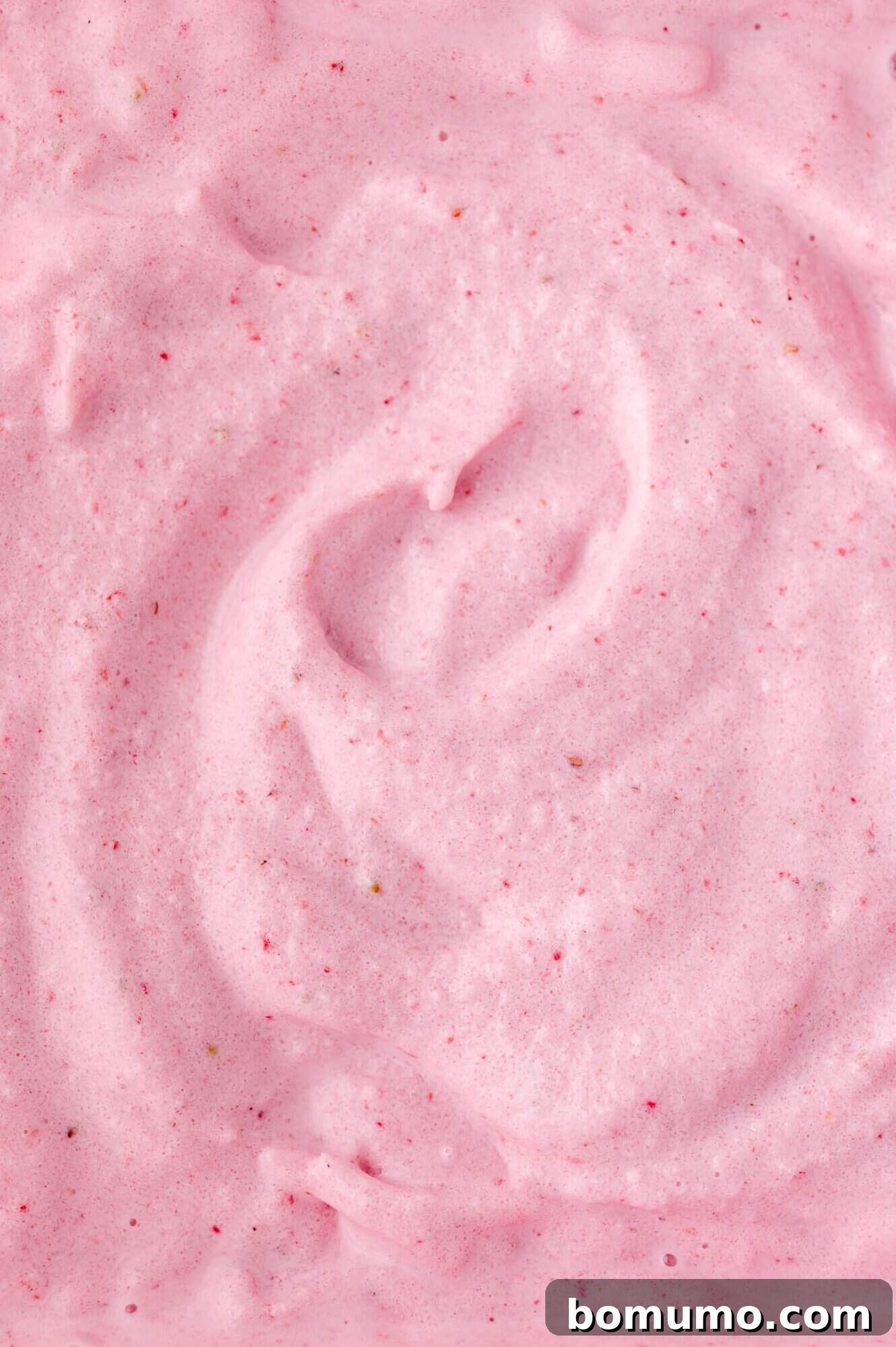 Velvet Strawberry Indulgence 6 An enticing close-up of a perfectly blended strawberry milkshake, showcasing its beautiful pink hue, smooth creamy texture, and tiny specks of real strawberry, inviting a refreshing sip.