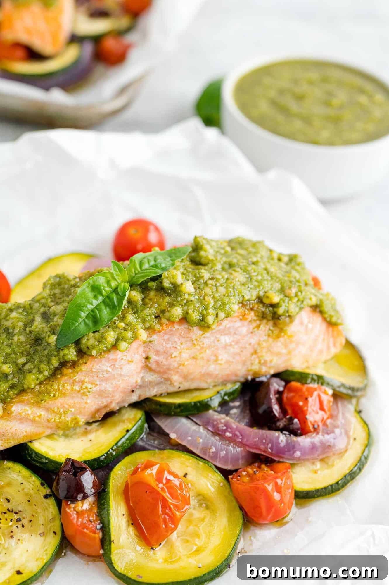 Pesto salmon with vegetables in parchment paper, presented beautifully, embodying a healthy and delicious meal.