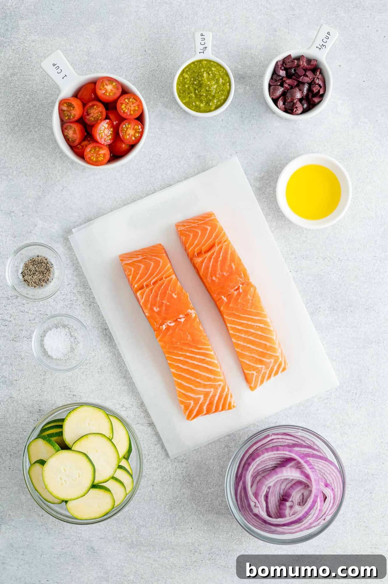 Essential ingredients for pesto salmon, including fresh salmon fillets and a vibrant assortment of vegetables.