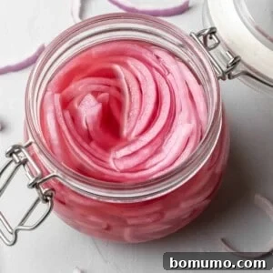 Overhead view of jar of pickled red onions.