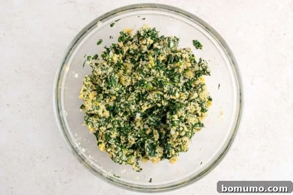 Spinach ball mixture in a glass bowl.