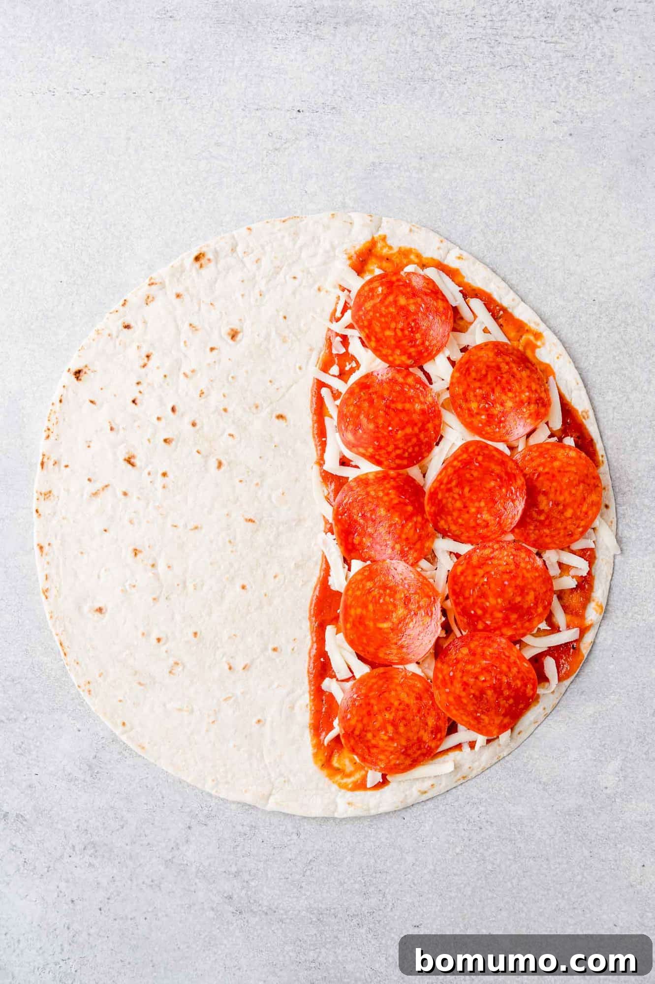 Pizza-Dilla Melt 6 Pepperoni and cheese meticulously added to one half of the tortilla over a layer of pizza sauce.