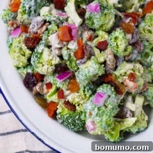 Healthy broccoli salad with bacon and red onion, a vibrant side dish.