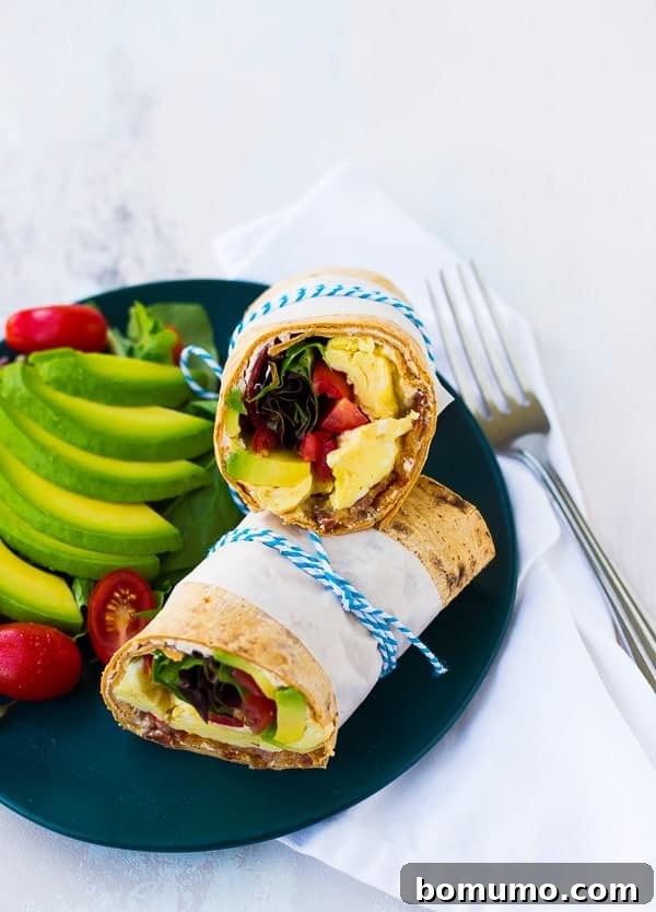 Loaded California Breakfast Wrap 4 Picture of wrap on plate with garnishes and fork.
