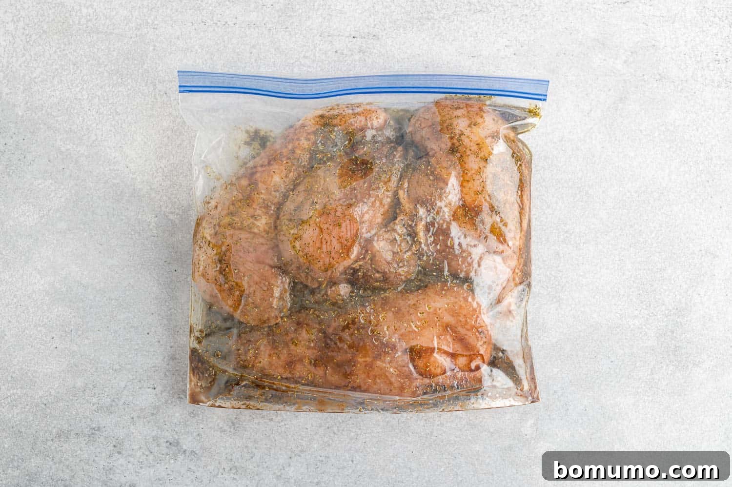 Chicken breasts marinating thoroughly in a zip-top bag, soaking up all the delicious balsamic flavors.