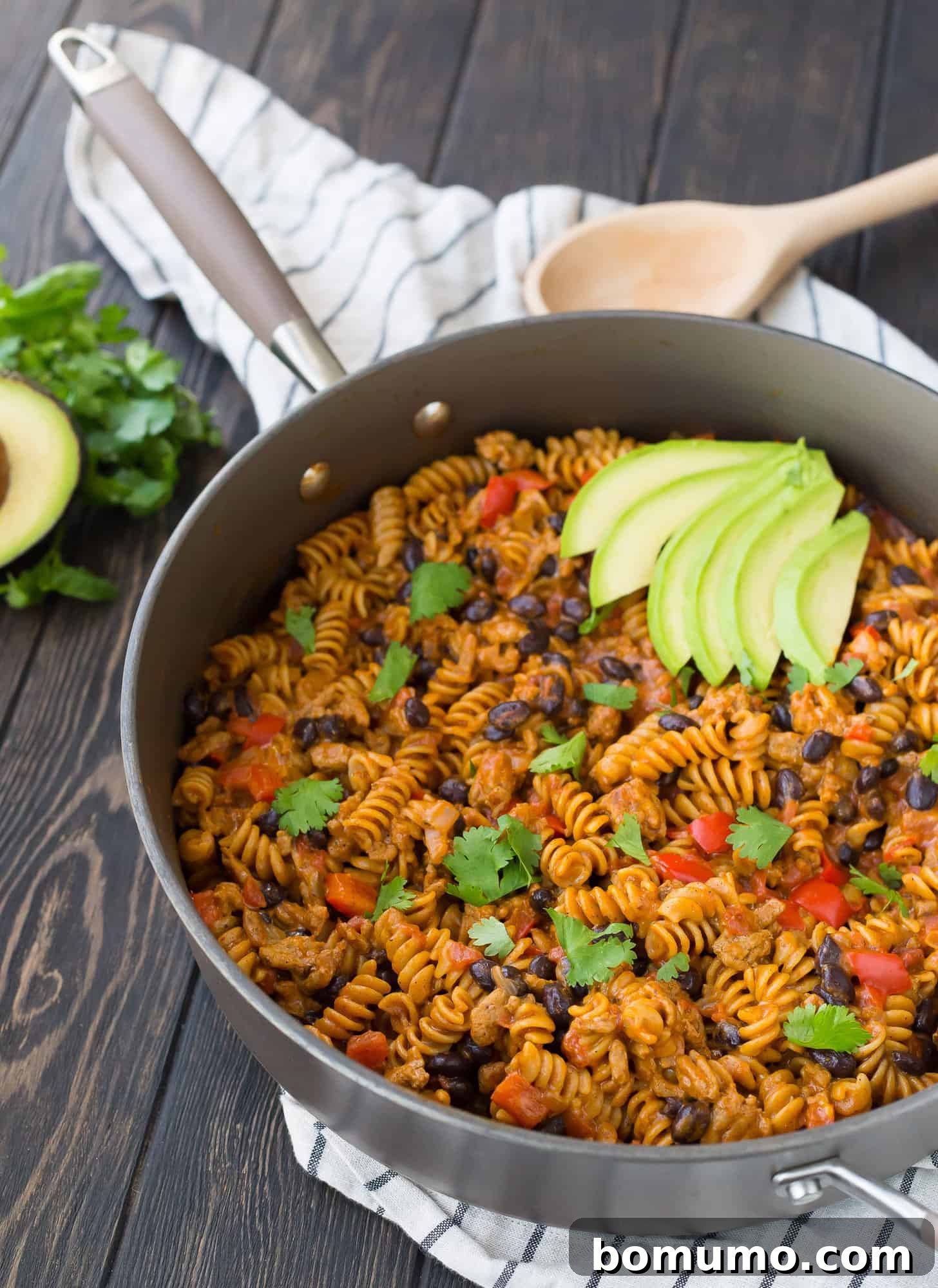 Hearty Taco Pasta, brimming with savory ground turkey, black beans, and colorful peppers, nestled in a skillet, ready to be served as a comforting family dinner.