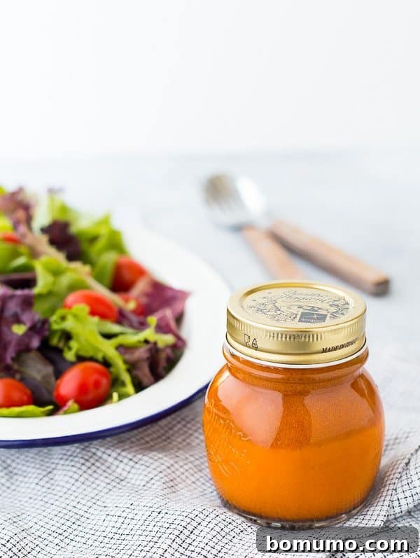 Close-up of fresh, vibrant Carrot Vinaigrette Salad Dressing showcasing its smooth texture and rich orange color, hinting at its natural, wholesome ingredients.