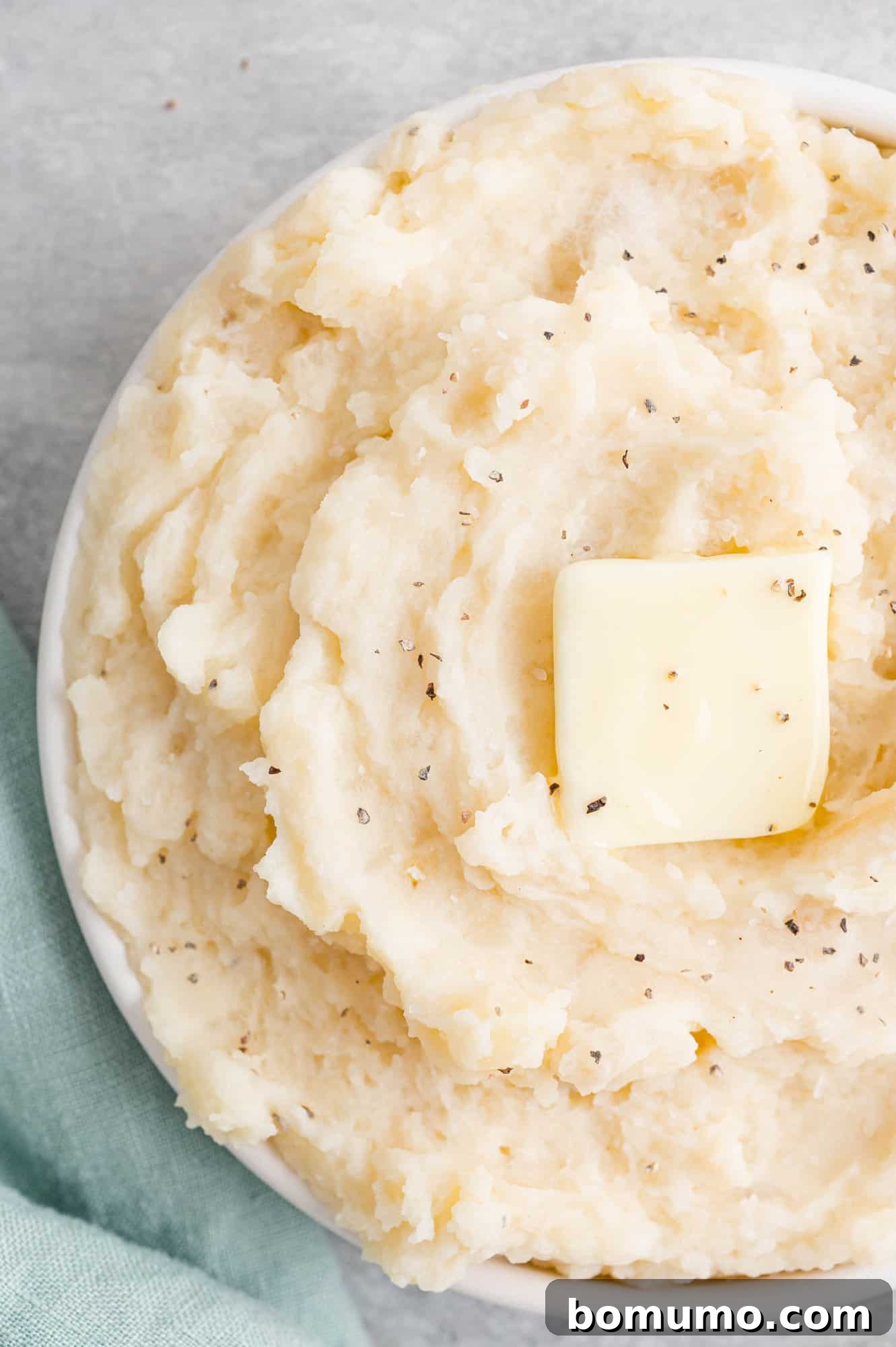 Set-It-and-Forget-It Mashed Potatoes 2 Creamy crockpot mashed potatoes generously topped with a pat of melting butter.