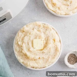 Crockpot mashed potatoes in a white bowl.