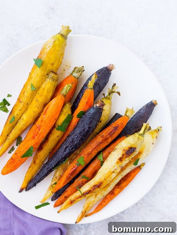 Perfectly roasted whole carrots with green tops, seasoned simply for a healthy side dish.