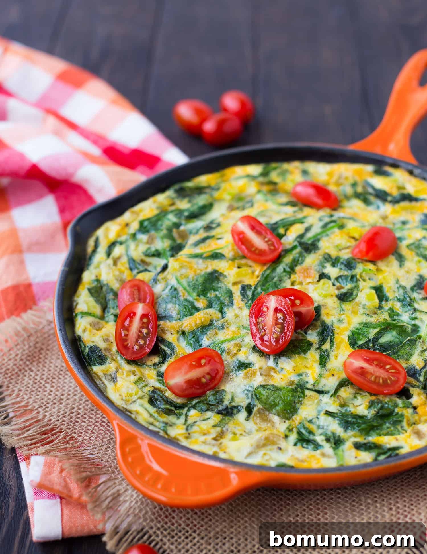 Egg White Chile Frittata 2 Egg white frittata topped with fresh tomatoes and herbs, ready to be served for a healthy breakfast.