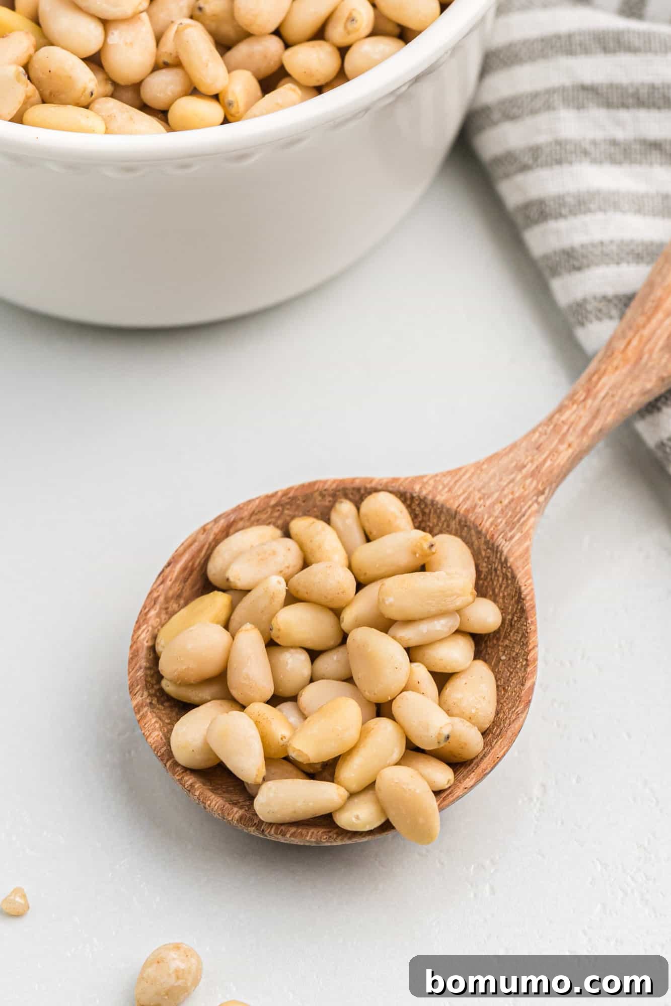 Untoasted pine nuts, showing their pale, creamy color before roasting.