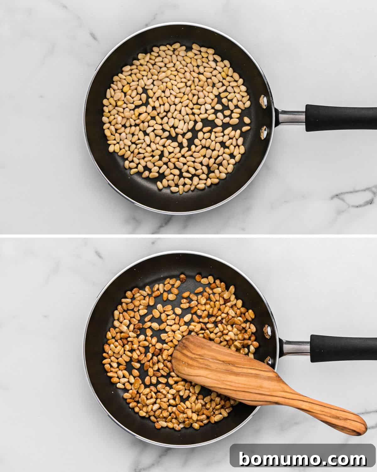 Pine nuts toasting in a non-stick frying pan on a stovetop.