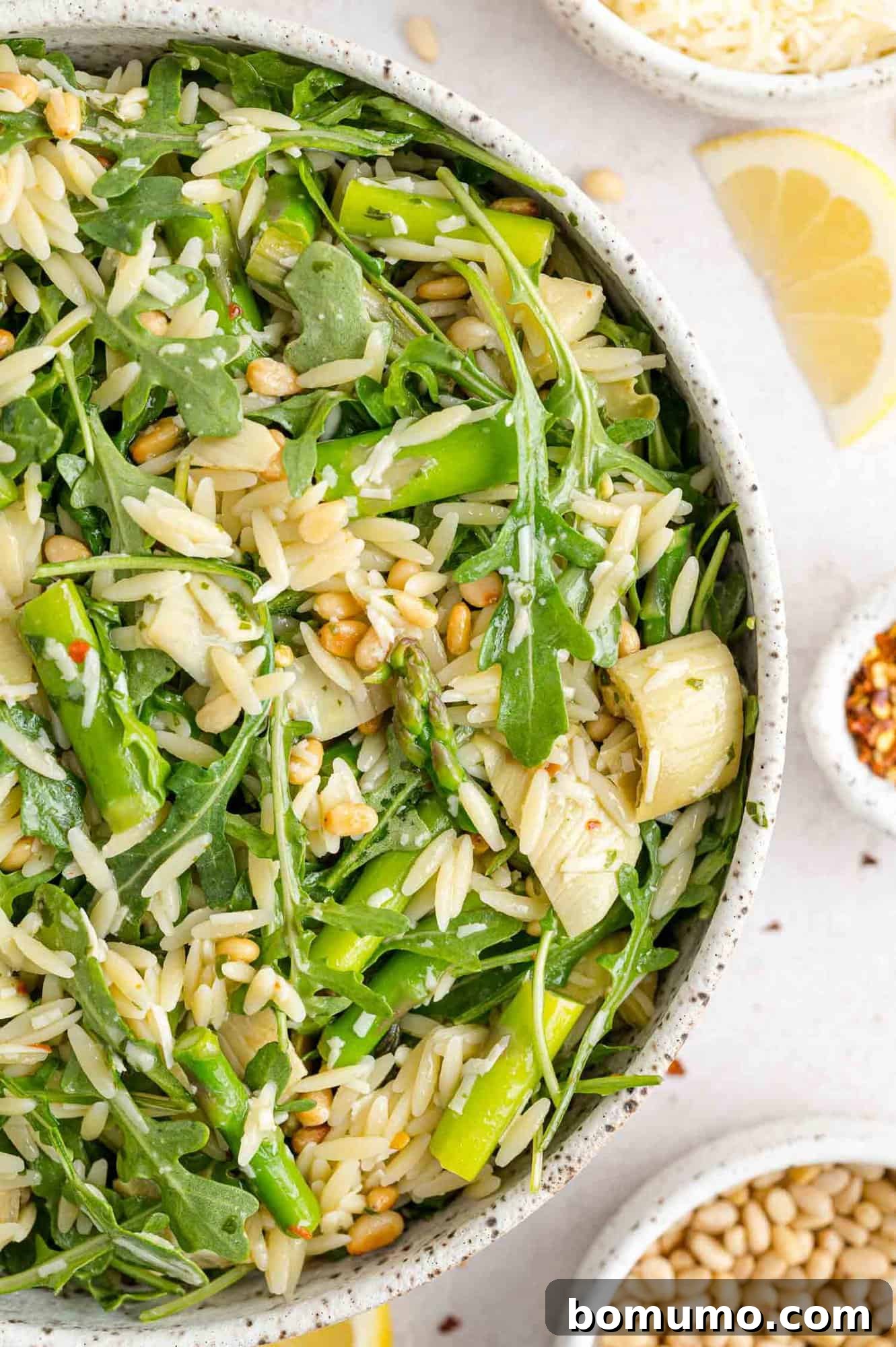 Orzo salad with arugula, asparagus, artichokes, pine nuts.