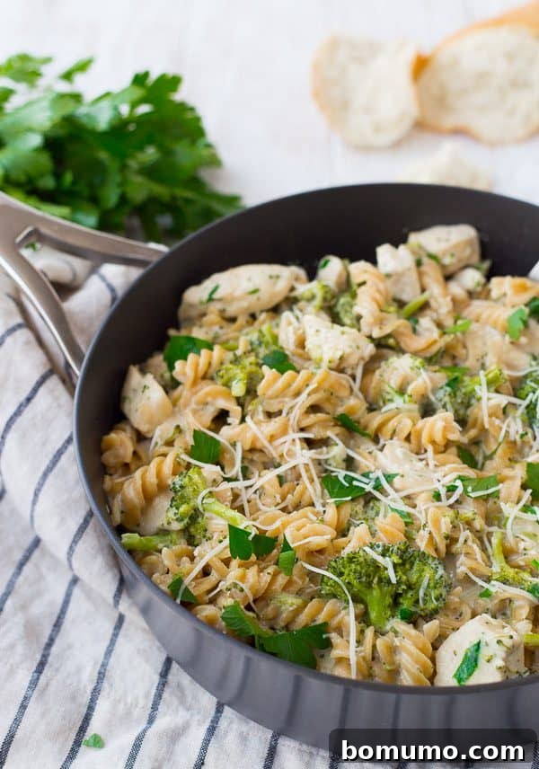 One-pan chicken Alfredo with parsley and bread, fresh from the skillet