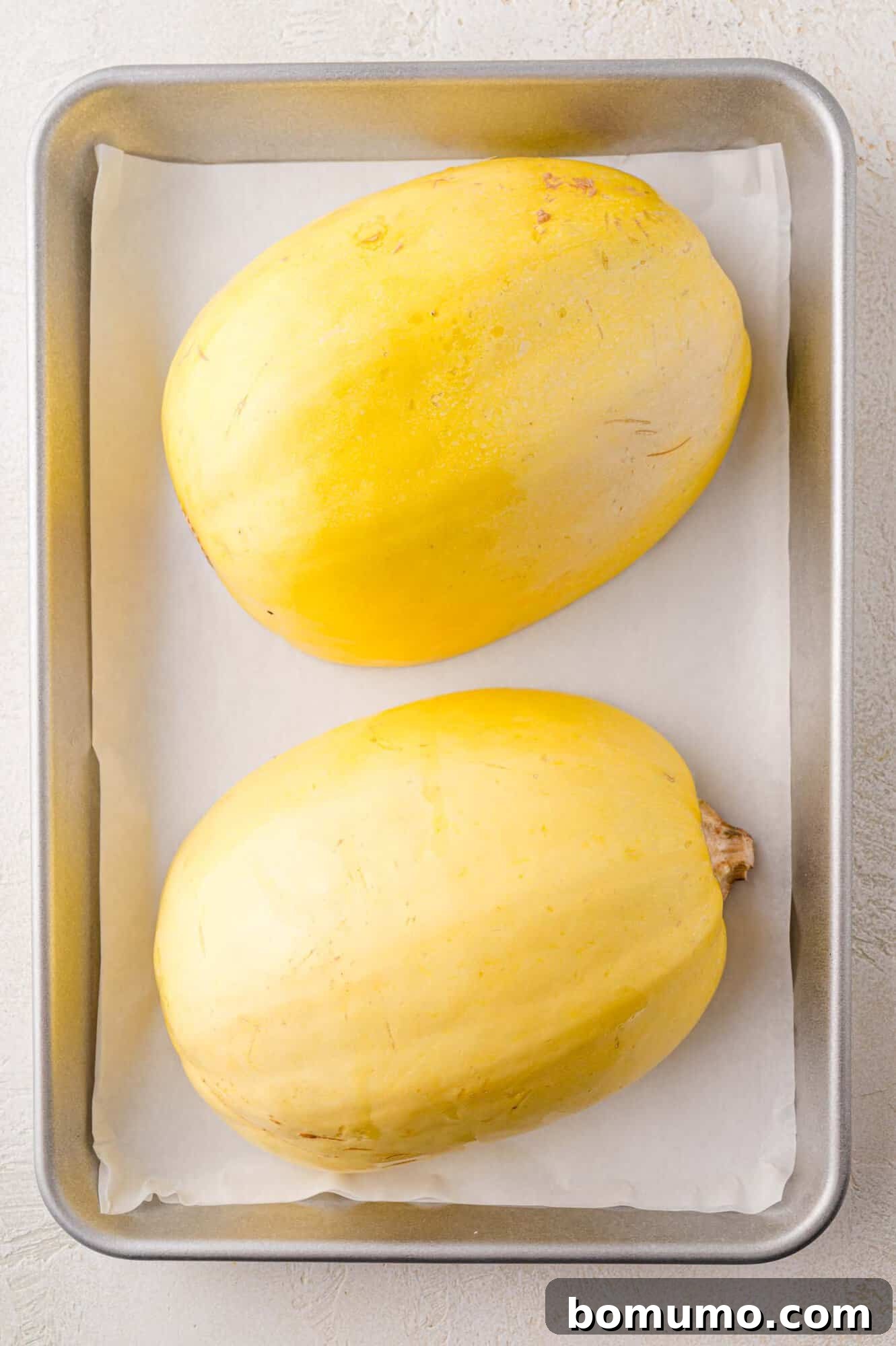 Spaghetti Squash Cooking Made Easy 12 Uncooked squash, face down on baking sheet.
