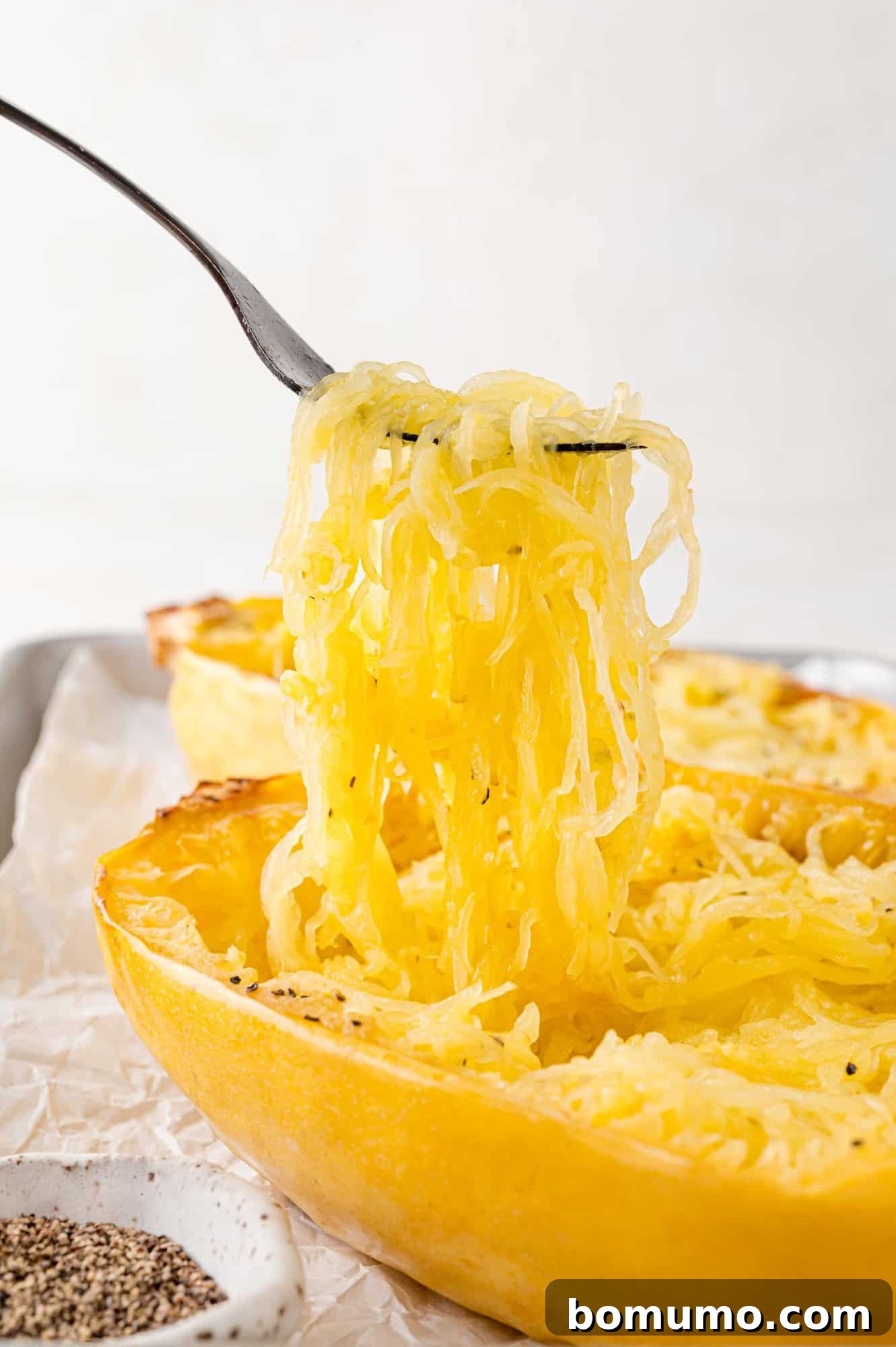 Spaghetti Squash Cooking Made Easy 14 Spaghetti squash being lifted out of baked squash half.