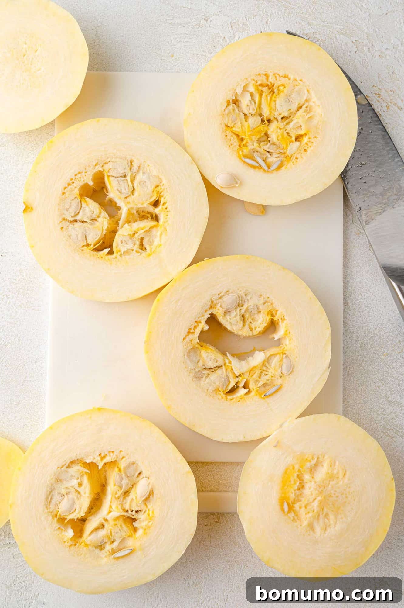 Spaghetti Squash Cooking Made Easy 3 Spaghetti squash cut into rings, seeds not yet removed.