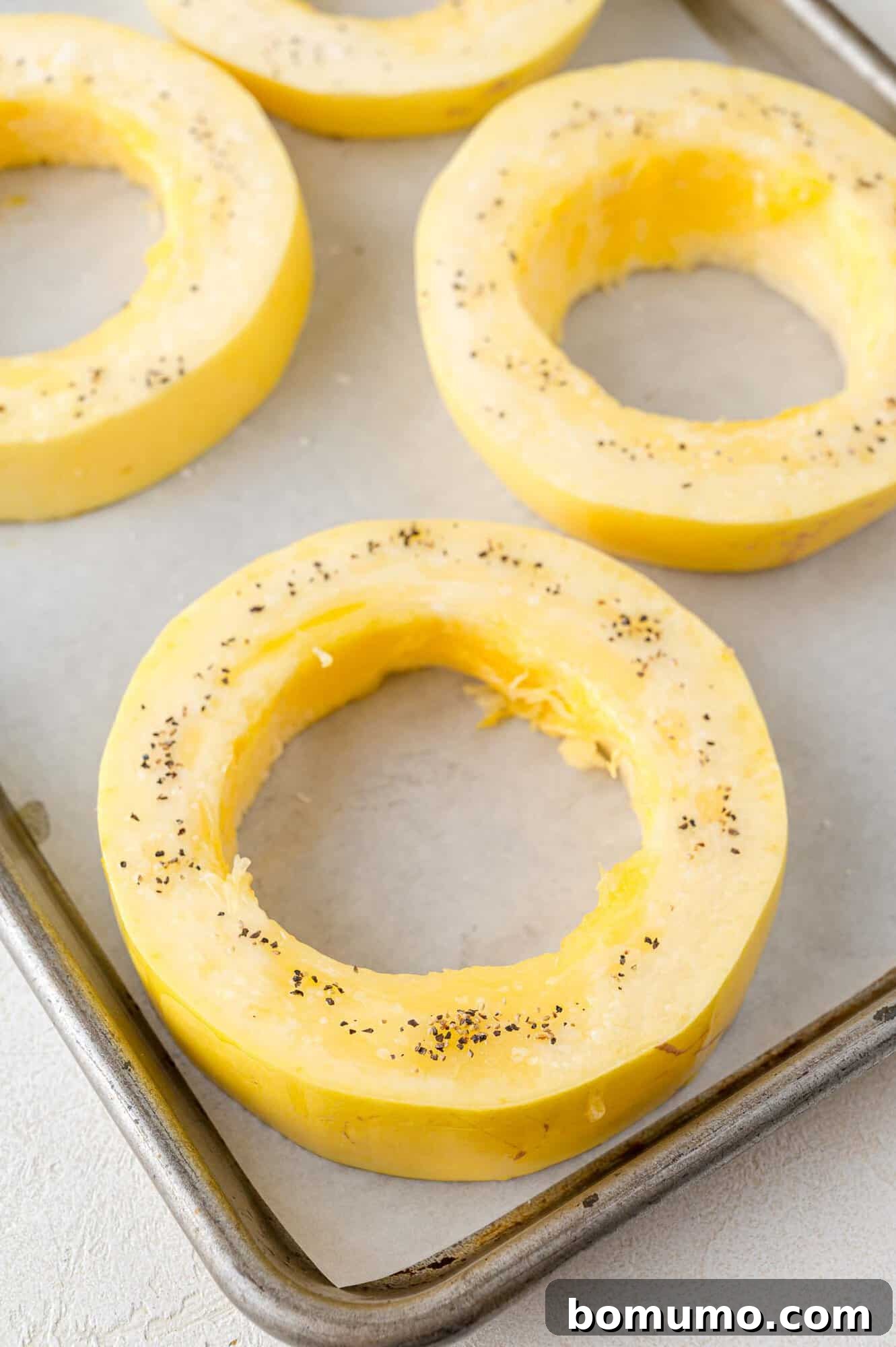 Spaghetti Squash Cooking Made Easy 5 Seasoned squash rings, ready to be baked.